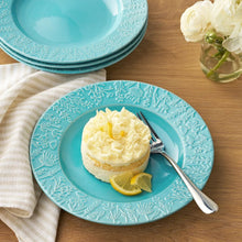 Blue ceramic salad plate with raised floral texture, round shallow shape