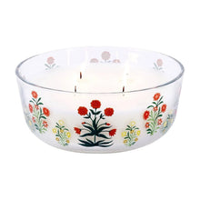 Floral glass candle jar with red flower bouquet print and lit wicks, white wax