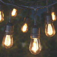 Outdoor LED café string lights with clear globe bulbs and black sockets on wire