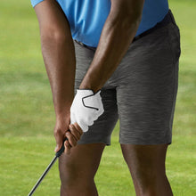 Golf glove clasping a golf club grip; white glove with black-trimmed wrist cuff