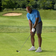 Golf glove worn on golfer’s hand with black-trimmed cuff while holding a club
