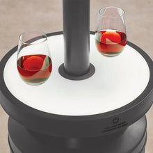 Patio heater with round LED table top and two glasses on the tabletop