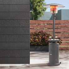 Gray patio heater with glass heater head, round base, and small side table