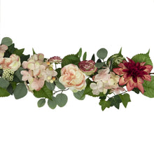 Pink and cream floral garland detail with roses, dahlias, and green foliage