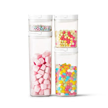 Two clear pantry storage containers with flip-lock lids, filled with colorful candies