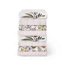 Kitchen towel set with folded white towels, floral sprigs, pink gingham and stripes