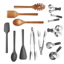 Stainless steel measuring spoons and cups with dark handles, multiple sizes