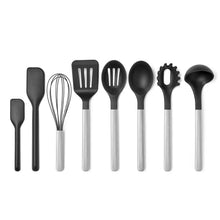 Black silicone cooking utensil set with stainless handles, eight-piece assortment