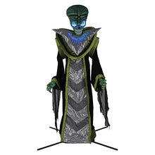 Animated alien yard decoration with teal head, silver chevron robe, green trim; blue-lit face