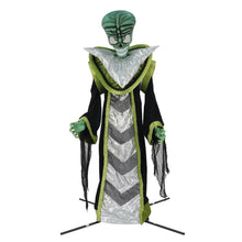 Standing alien yard decoration with teal face, silver zigzag robe, green trim, black cape