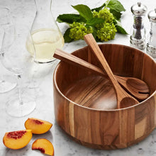 Acacia salad bowl with wooden servers and leafy garnish