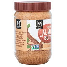 Almond butter jar with front label showing creamy almond butter text and brand name