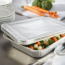 Aluminum steam table lid covering a half-size pan with vegetables