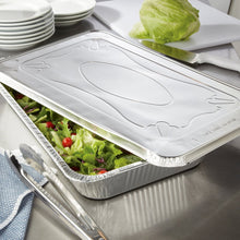 Aluminum steam table pan lid with embossed oval pattern, covering a foil pan