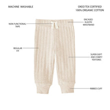 Infant rib knit pants in light cream, elastic waistband with tie, cuffed legs.