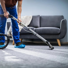 Carpet cleaner being extracted with a wand on a carpeted sofa