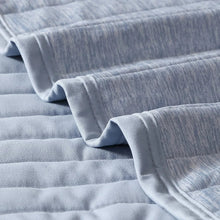 Light blue cooling throw blanket close-up of quilted channels and soft fabric trim