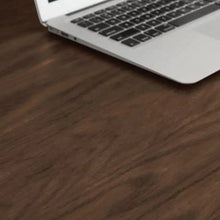 Dark brown desktop with visible wood grain and metal support edge