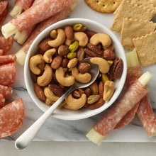 Bowl of mixed nuts with sea salt, cashews, almonds, and hazelnuts visible