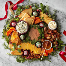 Holiday snack wreath with mixed nuts, crackers, and dipping bowl
