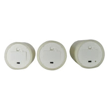Flameless LED wax candles, underside views showing battery compartments and ports