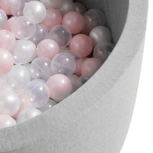 Gray foam ball pit filled with translucent pink and white balls