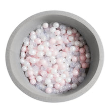 Gray foam ball pit filled with white, pink, and translucent balls