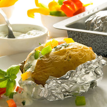 Foil-wrapped baked dish with herbs and vegetables, aluminum foil sheet