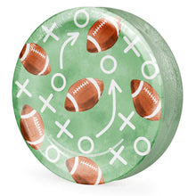Single football-themed paper plate with green background and white football game symbols