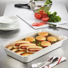 Rectangular aluminum steam table pan filled with sandwiches, produce, and herbs