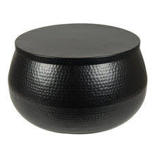 Round black hammered metal coffee table with closed lid, black textured finish