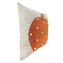 Decorative accent pillow with orange pumpkin applique on beige fabric, white dot details