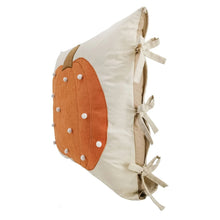 Decorative accent pillow showing side with orange pumpkin panel and beige ribbon ties