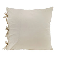 Decorative accent pillow with plain beige cover and small fabric ribbon ties