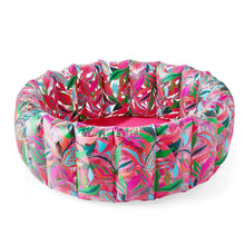 Inflatable lounge pool with bright tropical leaf print in pink, green, and blue