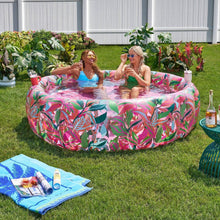 Inflatable lounge pool with pink, green, and blue tropical leaf print, round inflatable tub