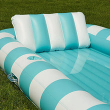 Inflatable sun tub with blue and white striped sides and raised headrest