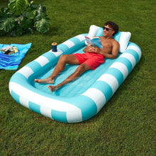 Inflatable sun tub with blue and white striped sides and blue interior on grass
