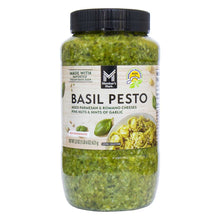 Basil pesto jar with black lid, filled with green pesto.