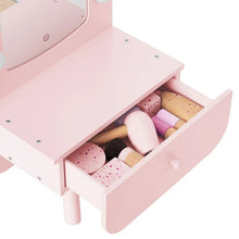 Pink tabletop vanity with open drawer showing molded makeup sets and tools