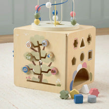 Wooden activity cube with bead maze, tree panel, and open door cutout