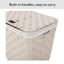 Laundry hamper with flat lid and woven sides, white top trim and folded fabric inside