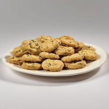 Pile of lemon blueberry cookie thins on a white plate