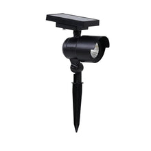 Matte black LED solar spot light with cylindrical head and flat solar panel, ground spike
