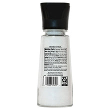 Sea salt grinder back label on clear glass jar with black lid