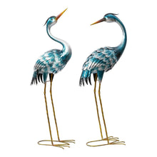 Metal crane statues set of 2, blue and silver cranes standing on thin gold legs.