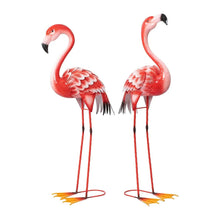 Two red metal flamingo yard statues with pink-white feather patterns, black beaks, circular feet