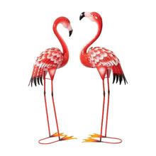Two red metal flamingo statues facing inward, feather-detail bodies, black beaks and stands