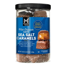 Milk chocolate sea salt caramels in a glass jar with blue label and black lid