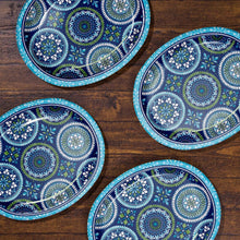Set of oval paper plates with blue and green mosaic medallion patterns on table
